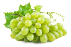 Green grapes with leaves. Isolated on white Green grapes with leaves. Isolated on white